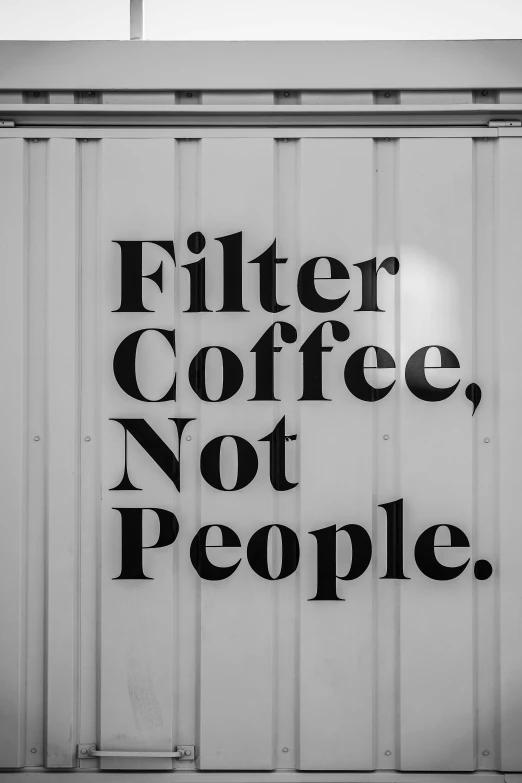 black and white image of a wall that says filter coffee not people