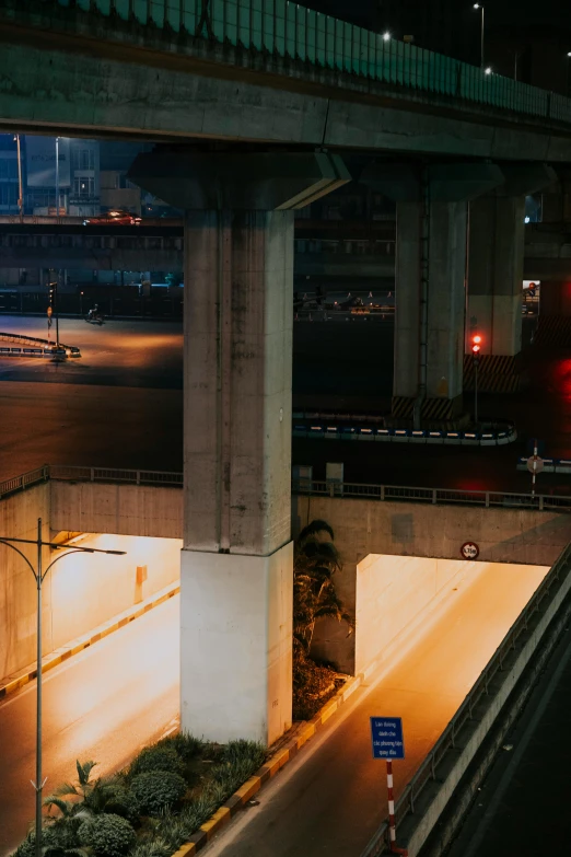 an elevated highway bridge at night with red lights