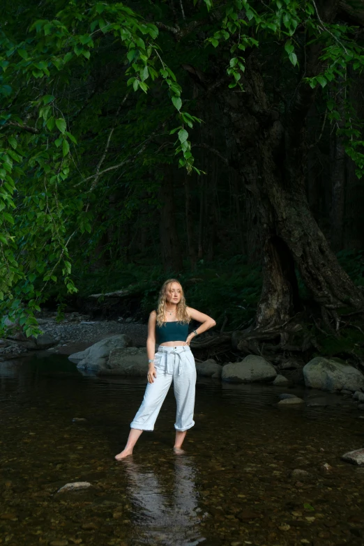 a woman posing for a po in the river