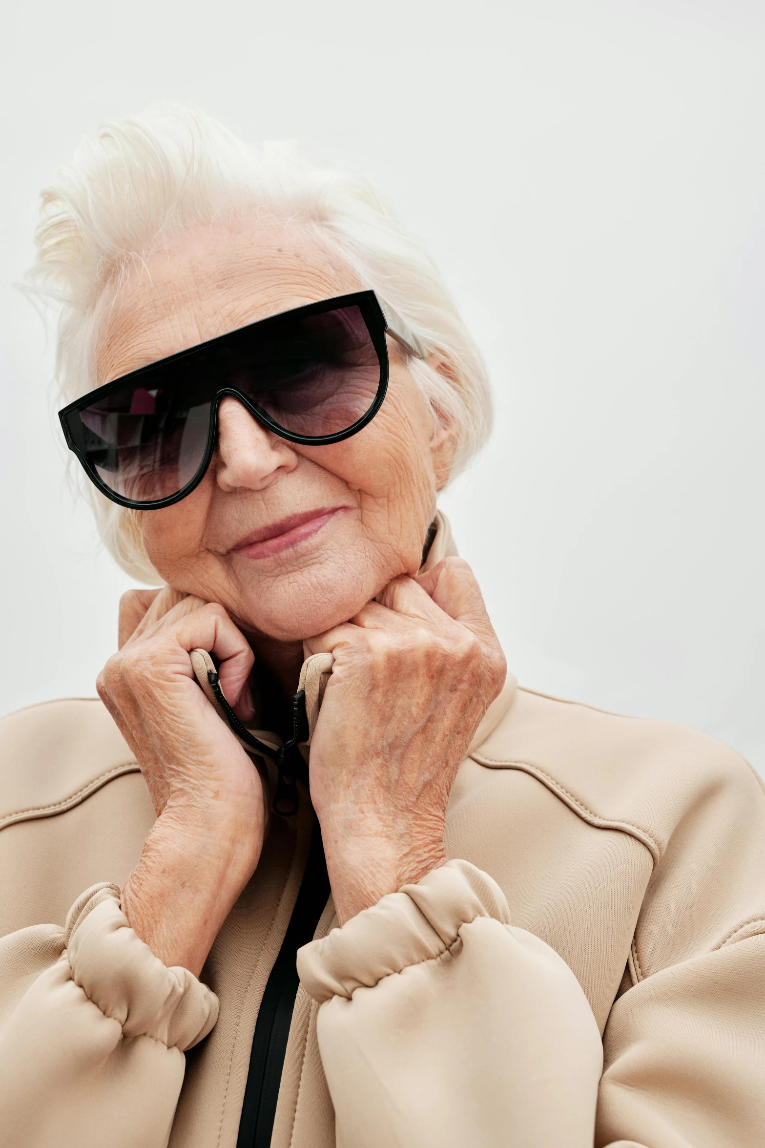 a woman wearing sunglasses poses for a po