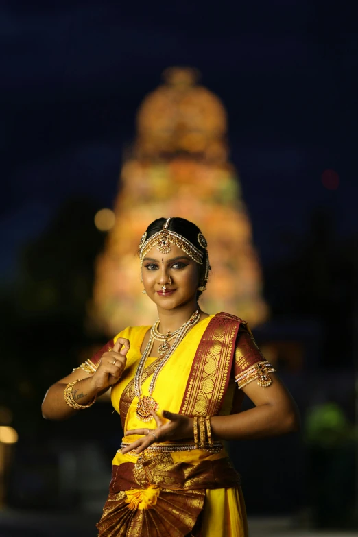 an indian woman is wearing yellow and brown