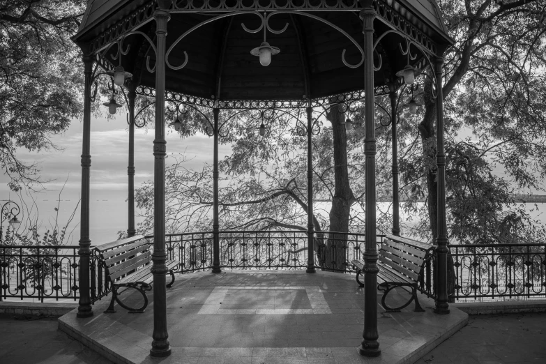 a very old style gazebo with some benches by it