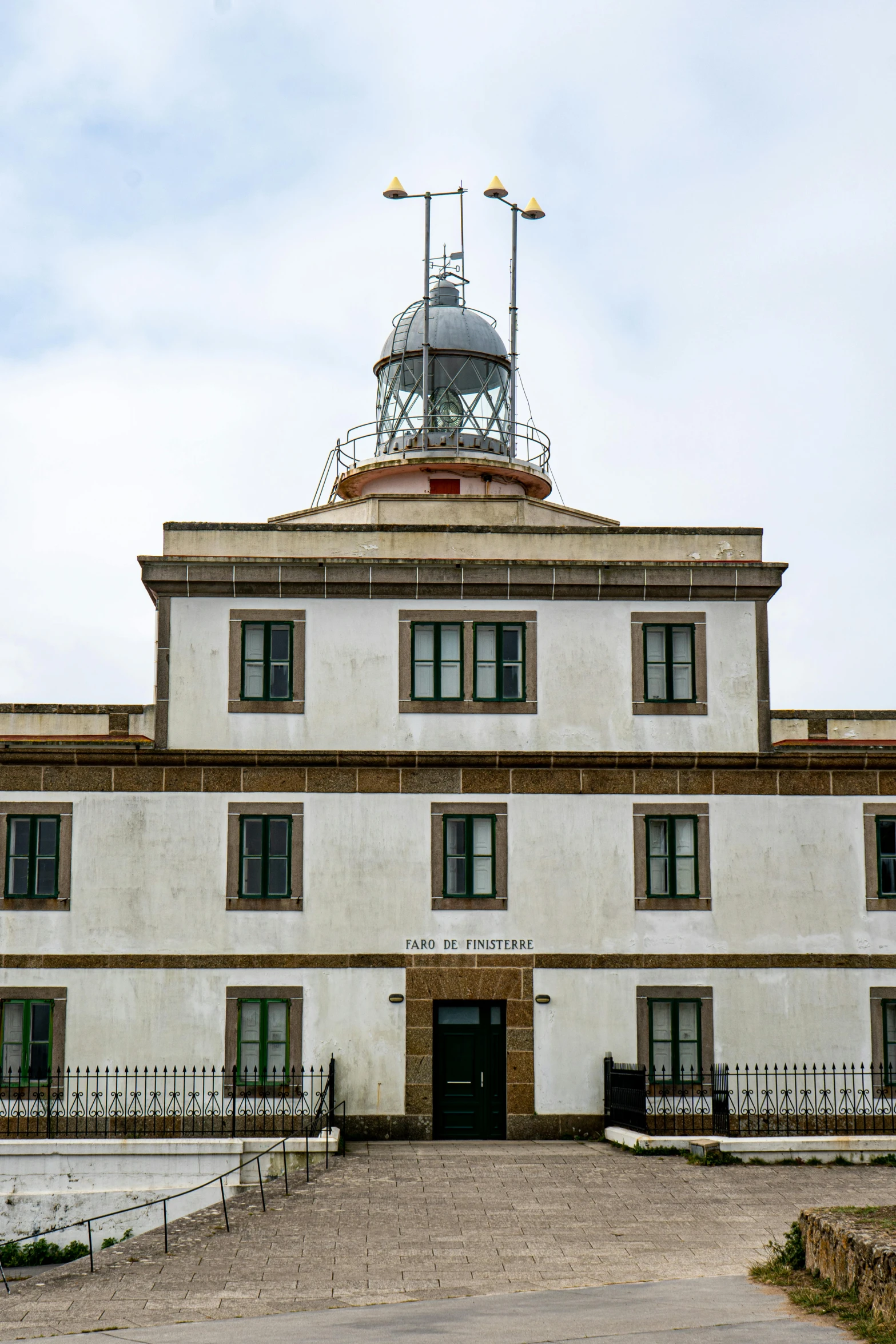 a white building with a very small clock tower