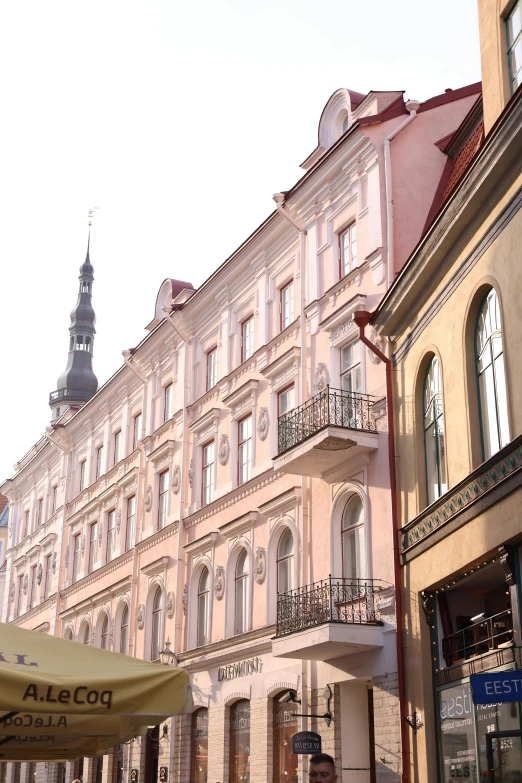 buildings on the street with a clock tower in the background