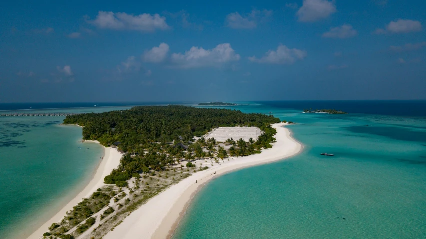 the ocean is blue and green with some small white buildings