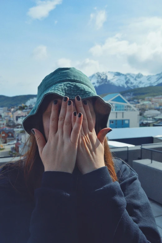 the girl is covering her face with her hands