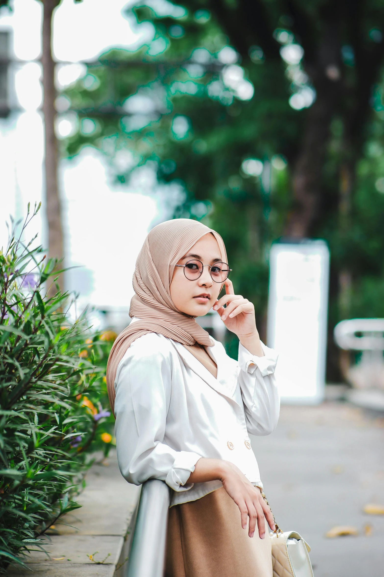 a woman wearing hijab is talking on the phone