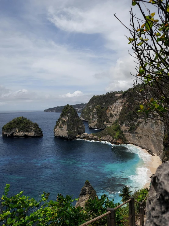 the rocky shore with two islands on the coast