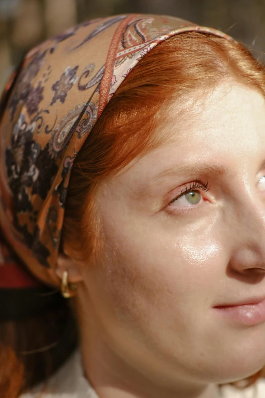 a young lady with red hair looking at soing