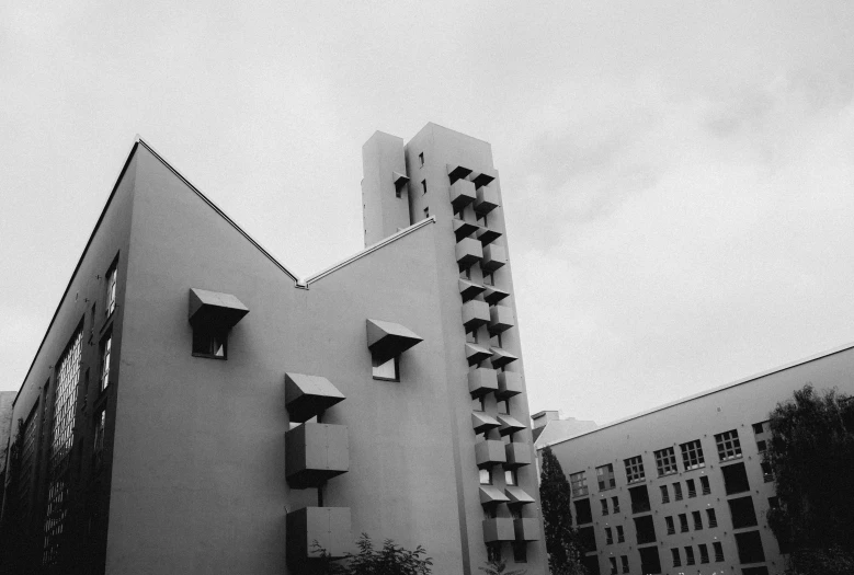 the top portion of a large building, with a clock displayed