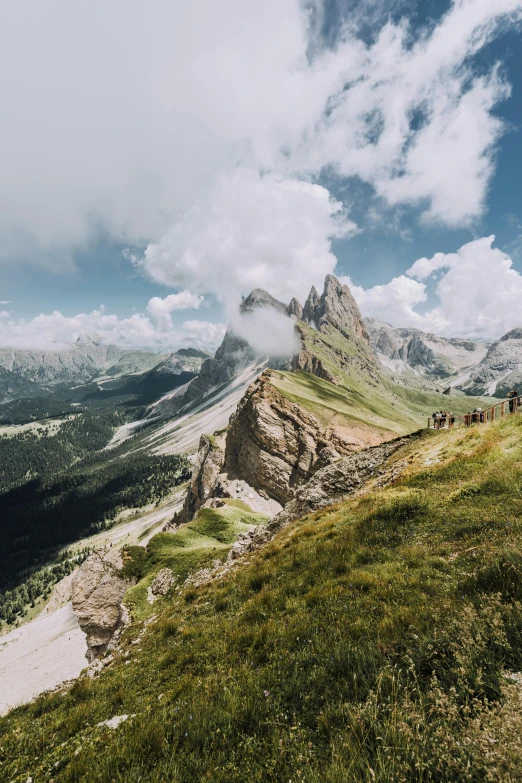 mountains and valleys are dotted with fluffy clouds