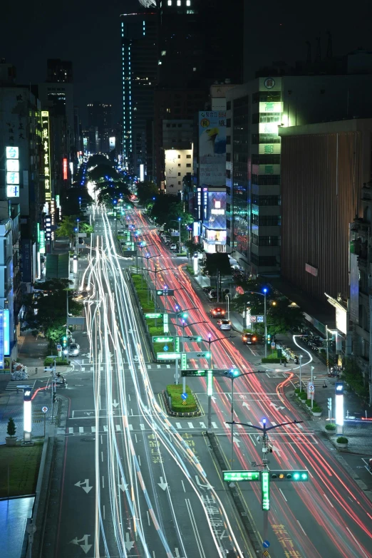 city at night with the lights of cars on the street