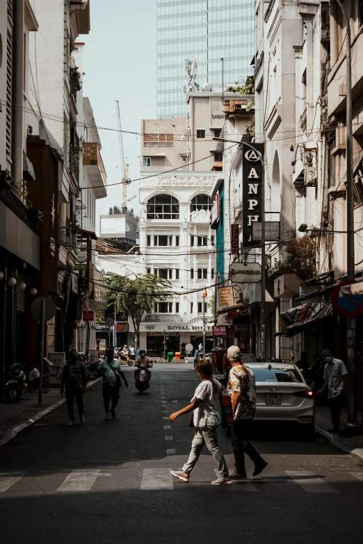 two men cross a road in a busy city