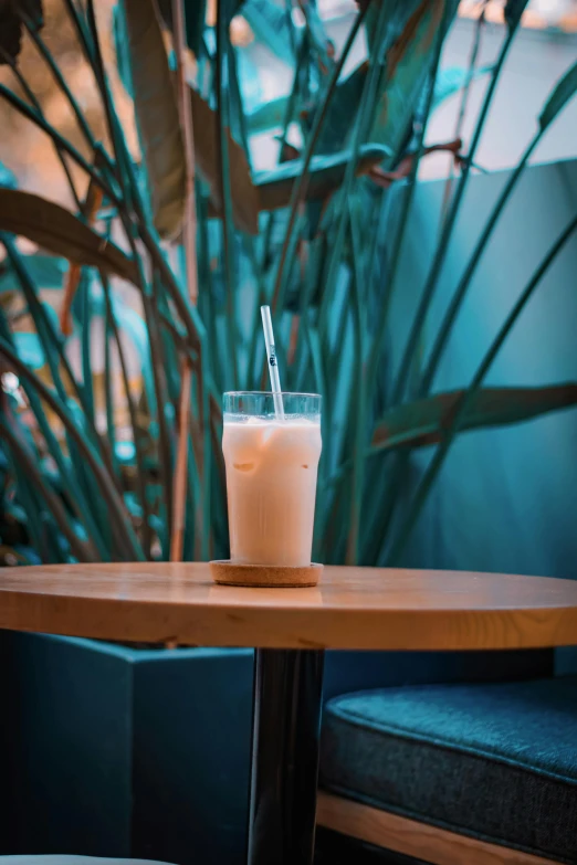 a glass with a straw in it sitting on a table