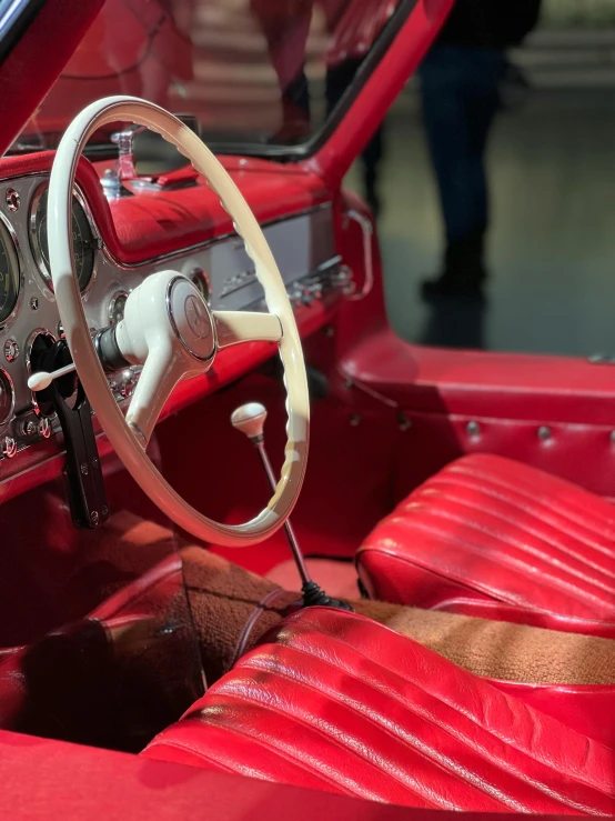 a close up of the interior of an old fashioned red sports car