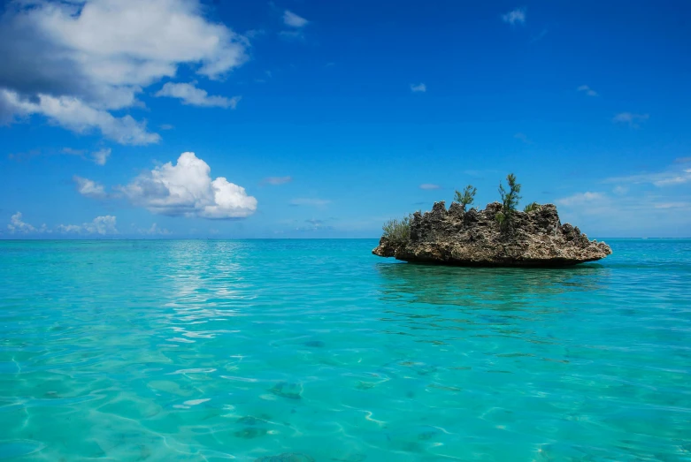 a rock is in the middle of the ocean