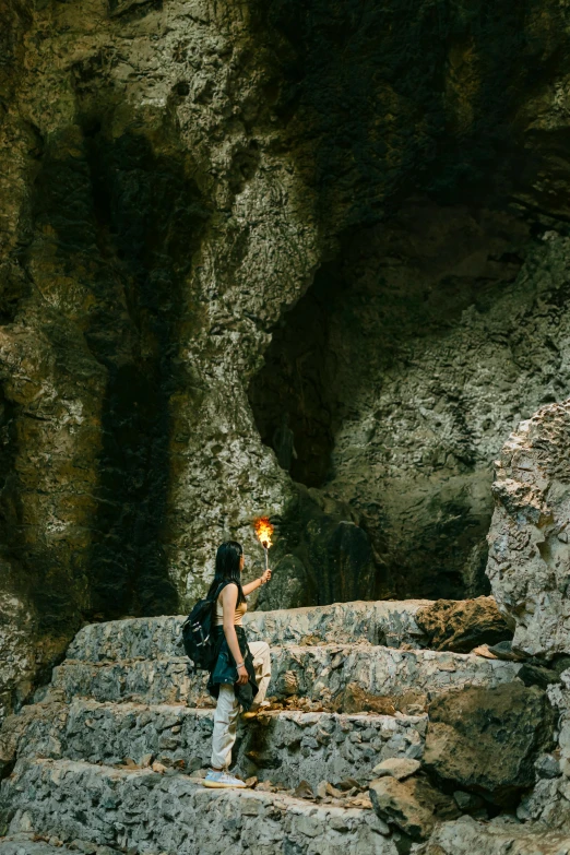 a woman is walking up steps carrying a lantern