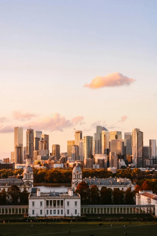 a large city on the horizon behind some tall buildings