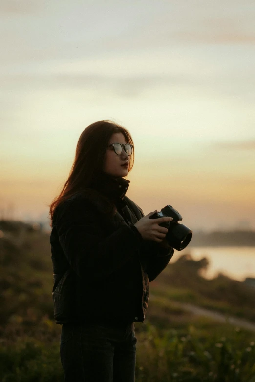 a person is standing outside and holding a camera