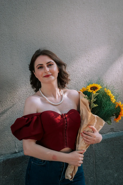 there is a woman with a brown jacket and flower bouquet