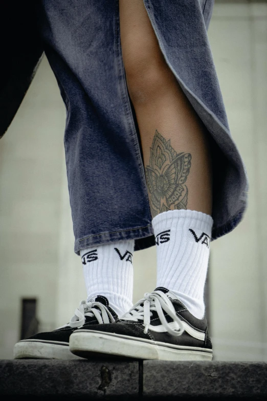 two mens socks with tattoos on them