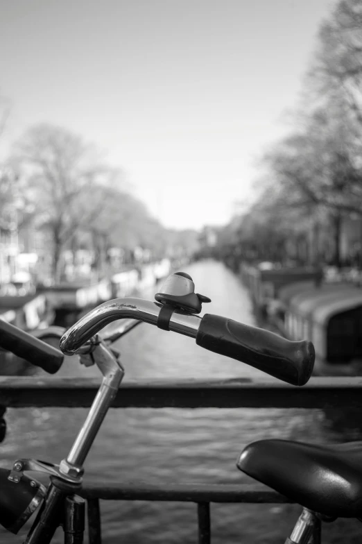 bicycle looking down the canal with boat docked next to it