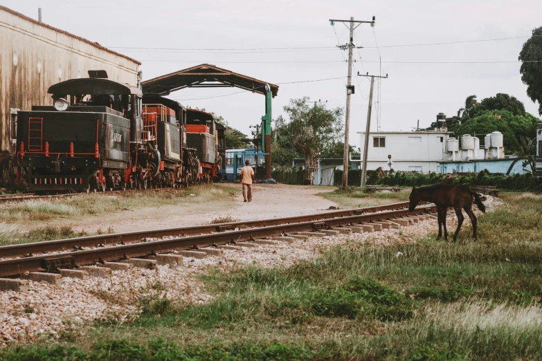 an old train on the railroad tracks at a station