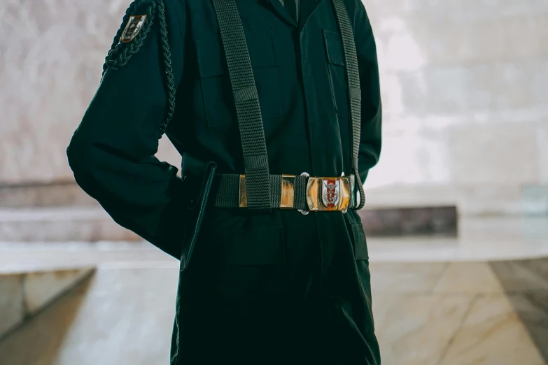 a person in a uniform stands with his hands on his hips