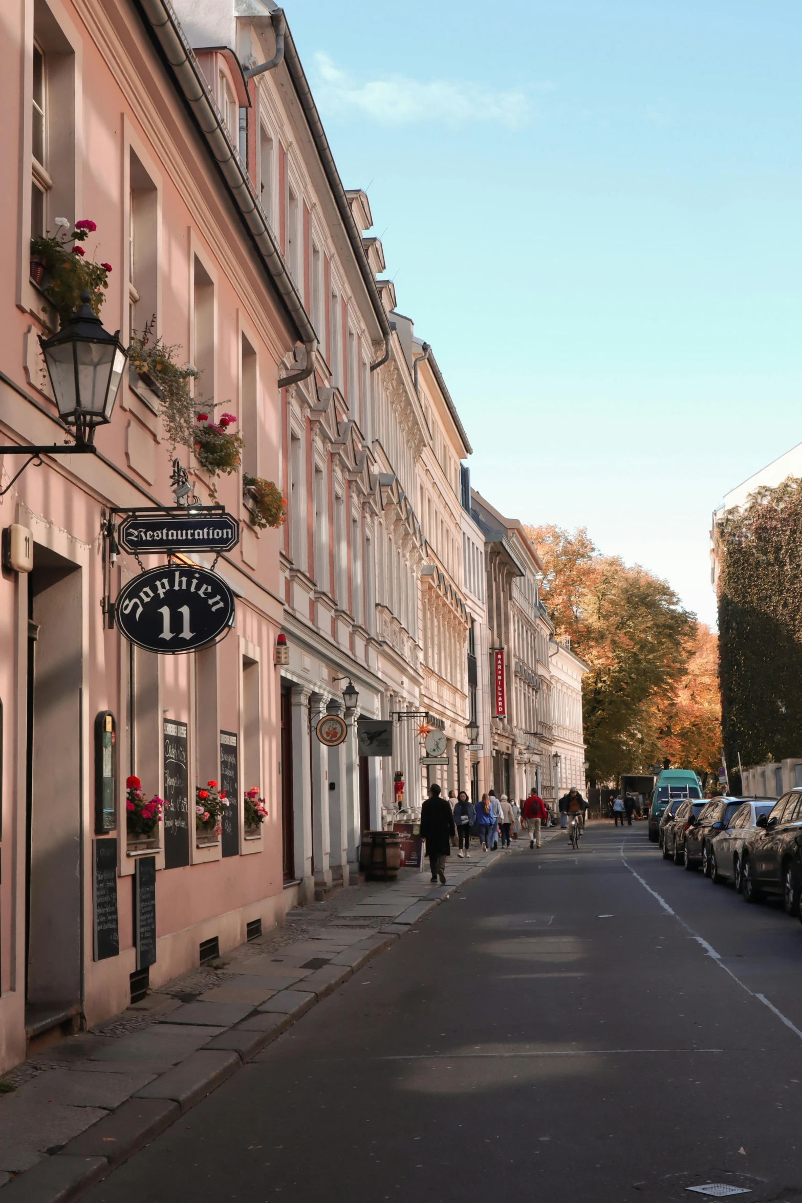 a very long narrow street that has a restaurant called la lunaette