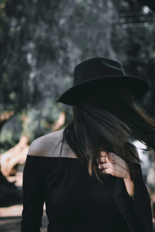 a woman with her hat back, looking like she has fallen from her back