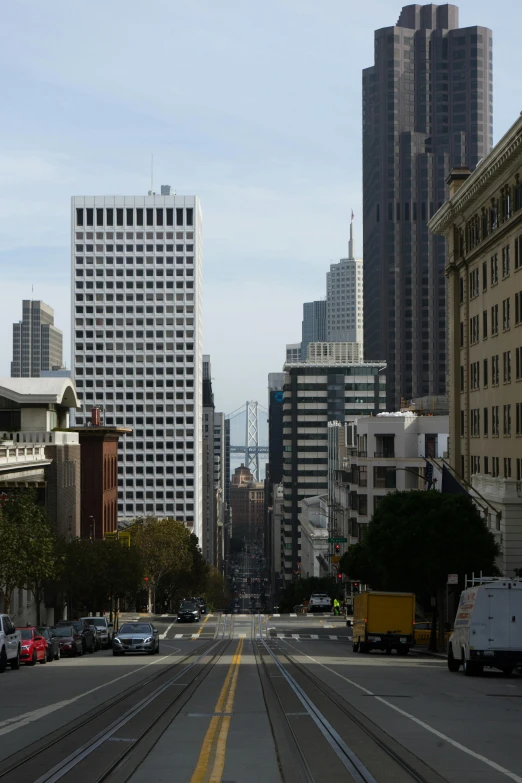 an urban street with large buildings in the distance