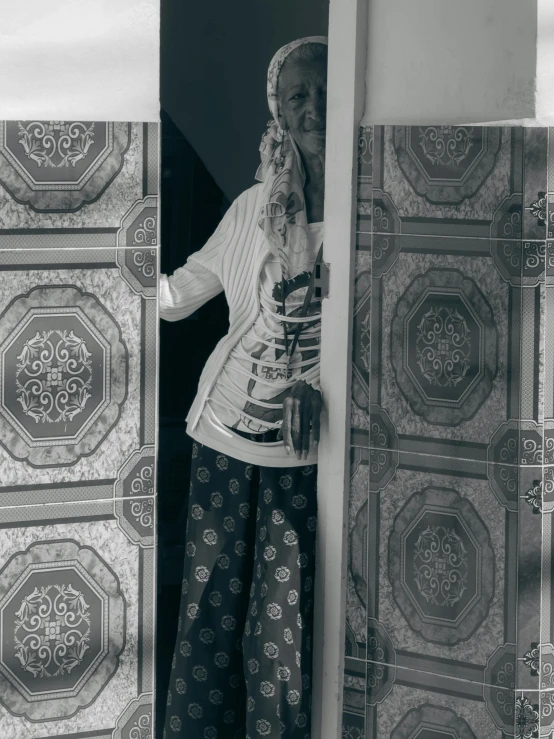 a woman holding a large cup standing in front of a window