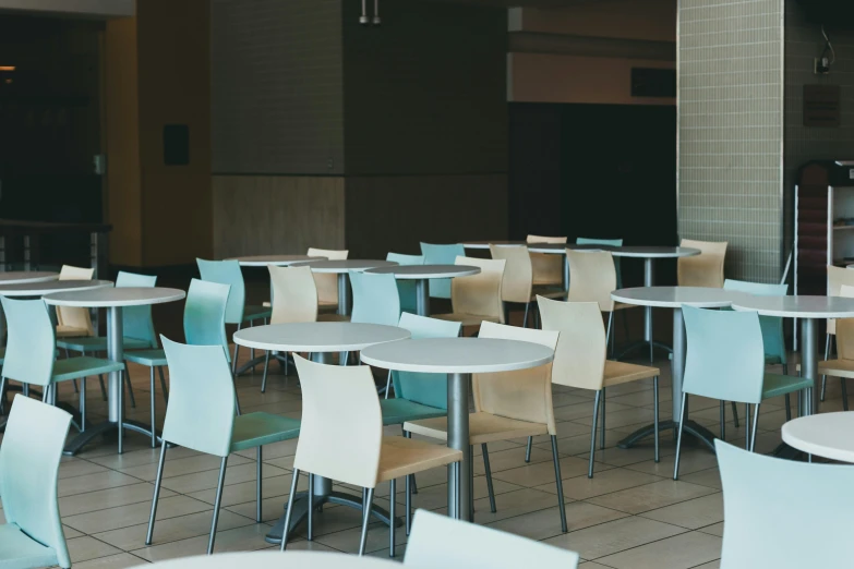 a number of tables and chairs near one another