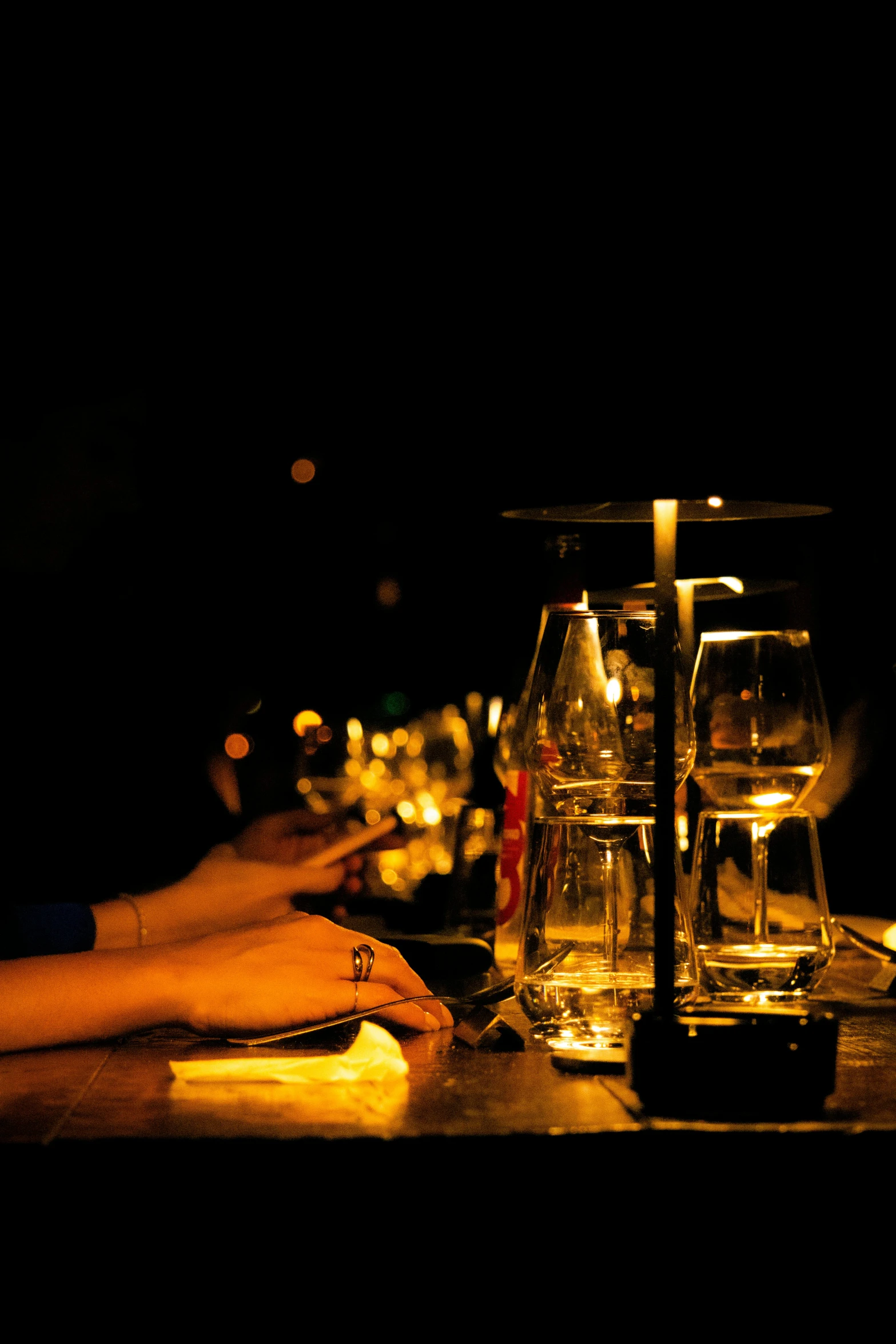 some glasses on a table with dark background