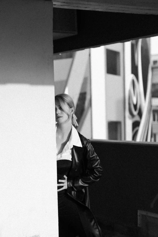 a black and white pograph of a woman sitting on a bench