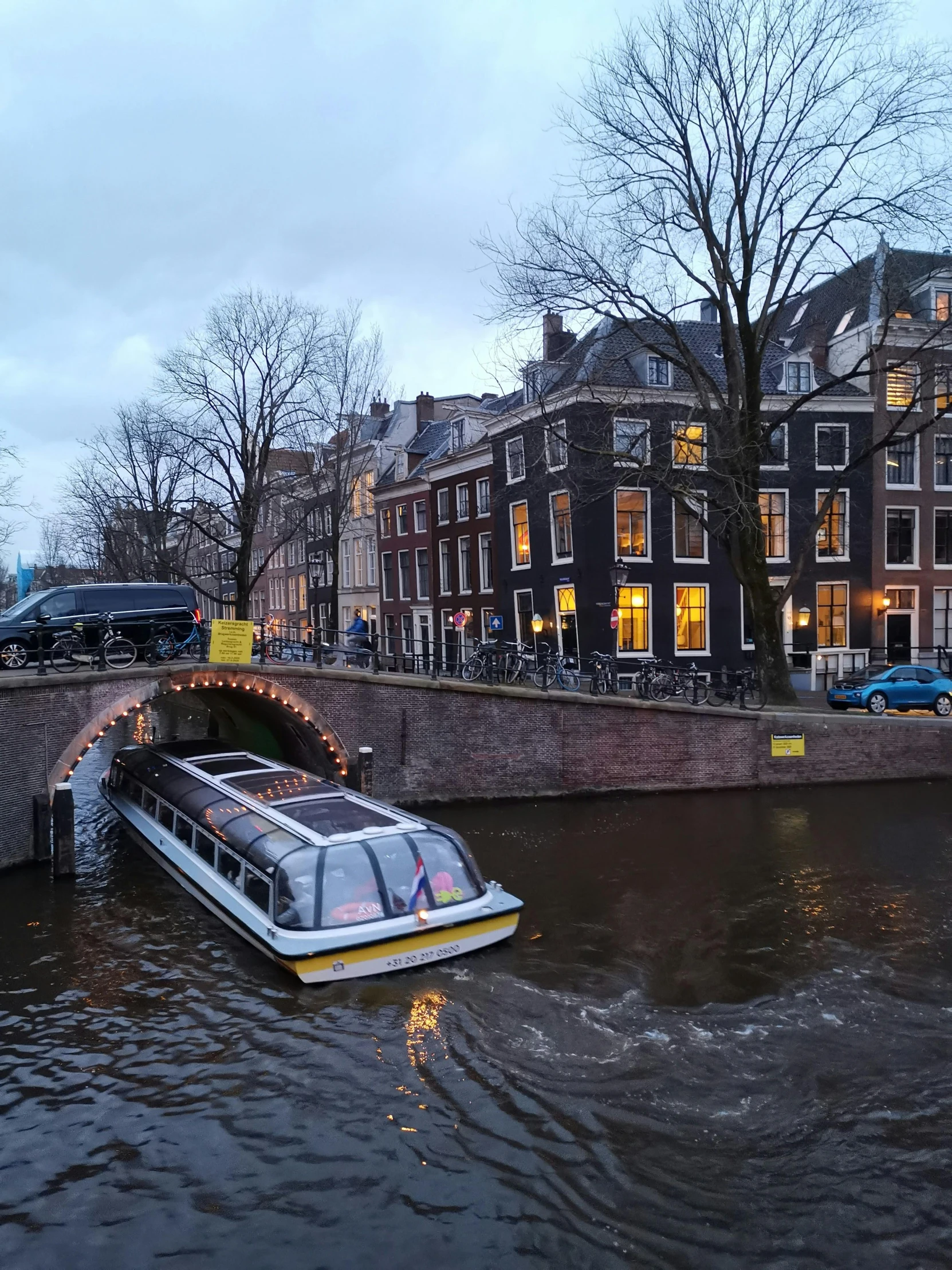 a boat traveling down a river by buildings