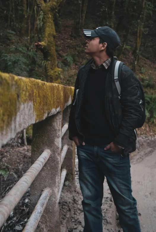 a man looking up into the sky over a bridge