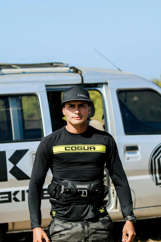 a person in full gear standing beside a car