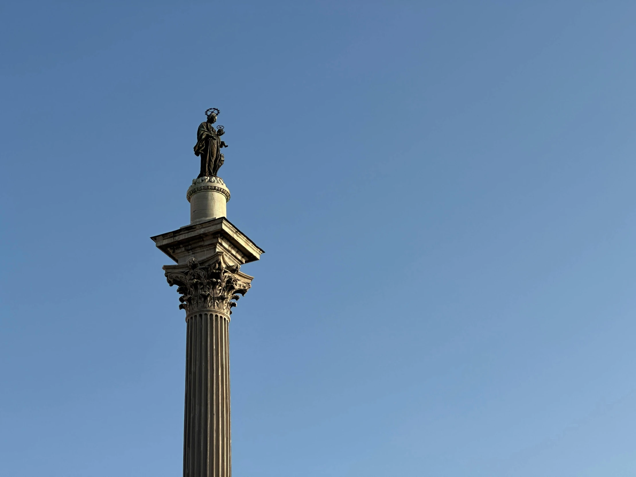 a tall tower that is under a blue sky