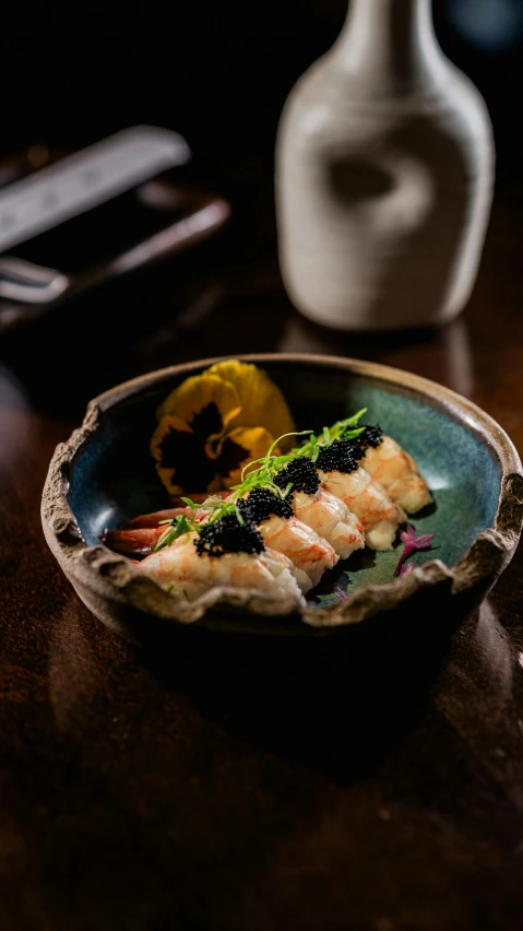 fish on a plate with a glass jar behind it