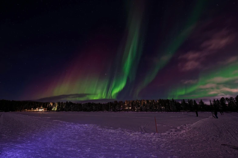 the aurora lights above the town in wintertime