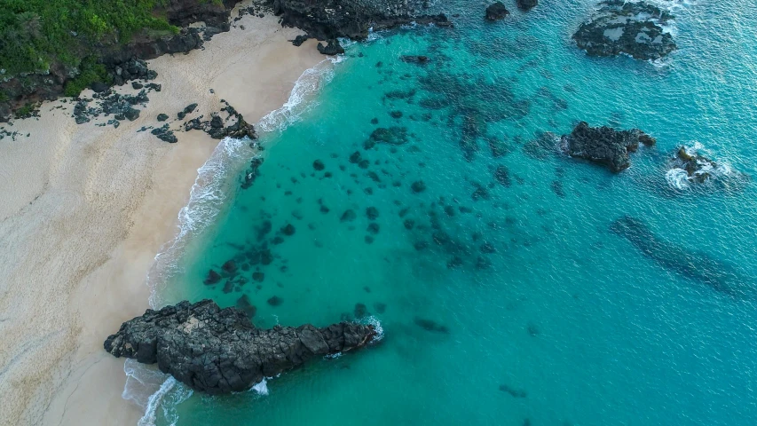 a beautiful beach with lots of blue water next to it