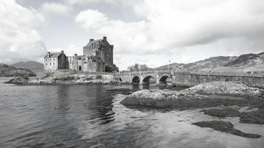 a castle on an island with a bridge going under it