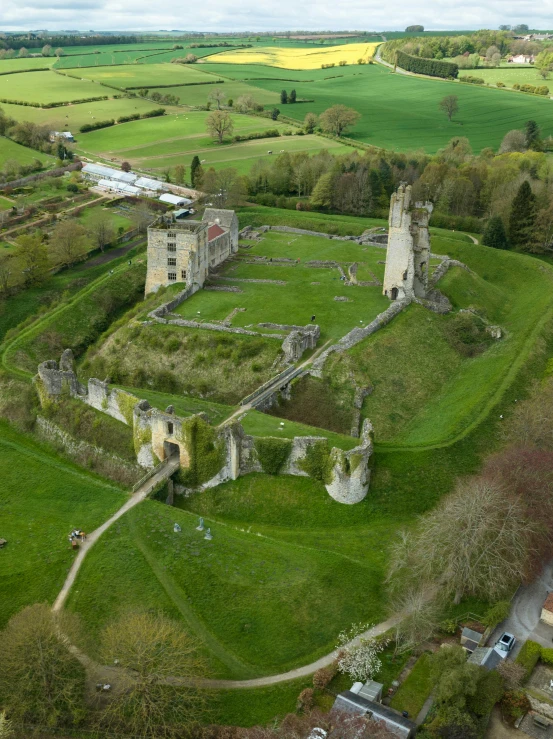 an aerial s of a castle near a lush green field