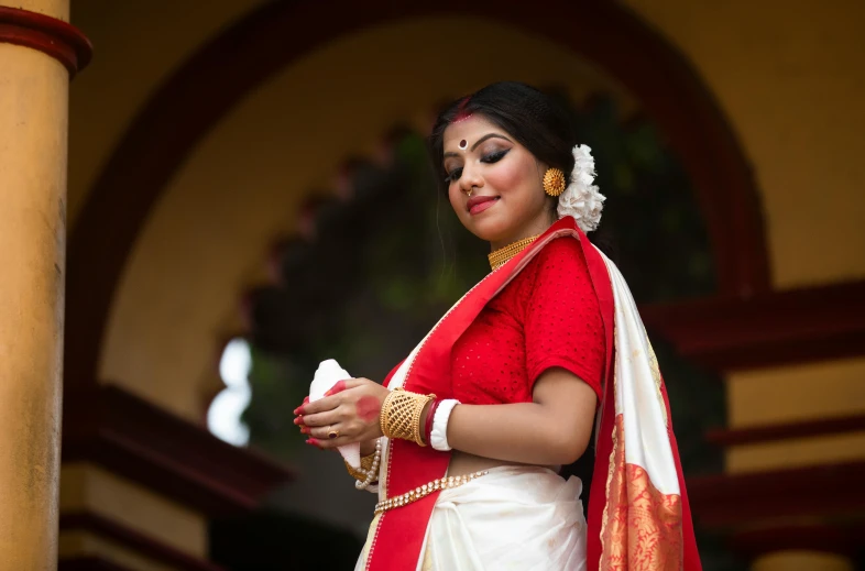 a woman in a red and white sari