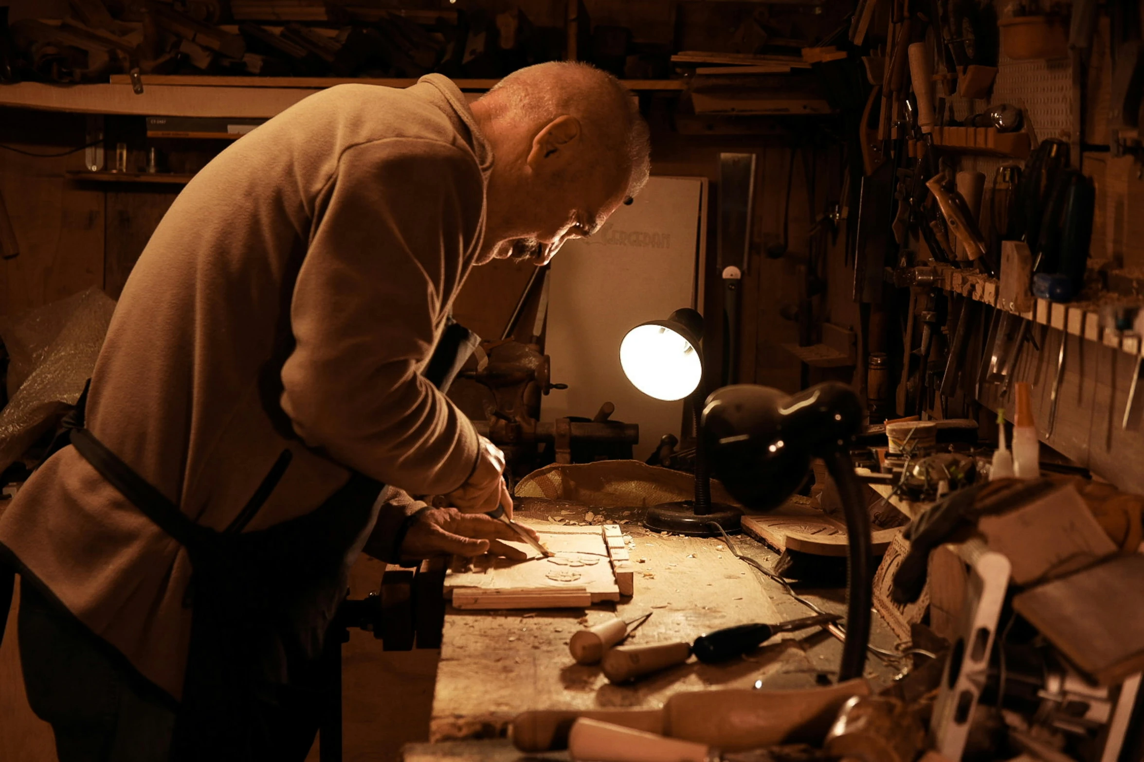 a man working in a shop, making soing