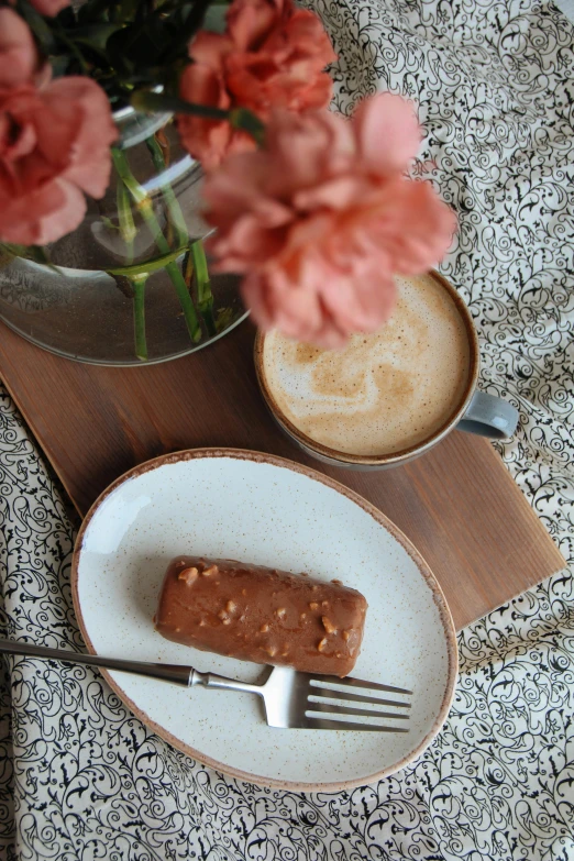 a table that has flowers and two plates on it