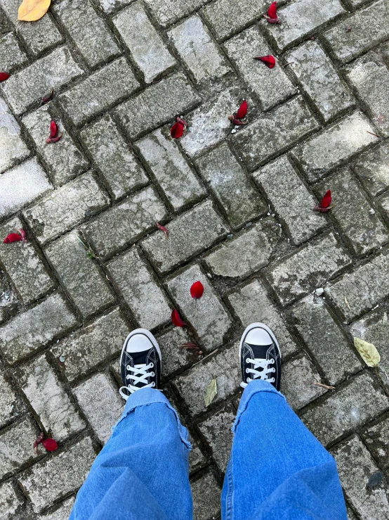 a pair of feet that are standing in the street