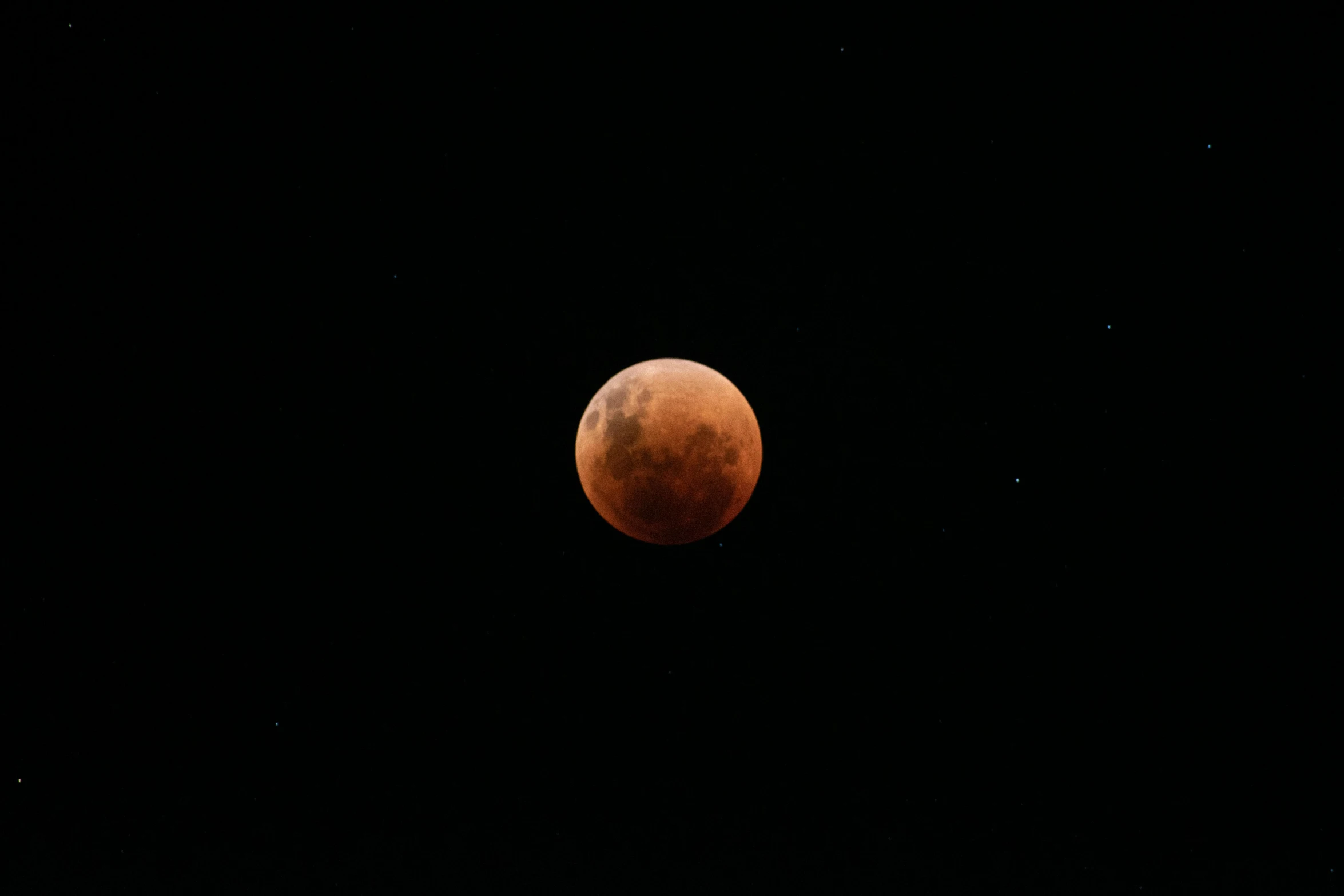 red moon in a black sky as the moon is very bright