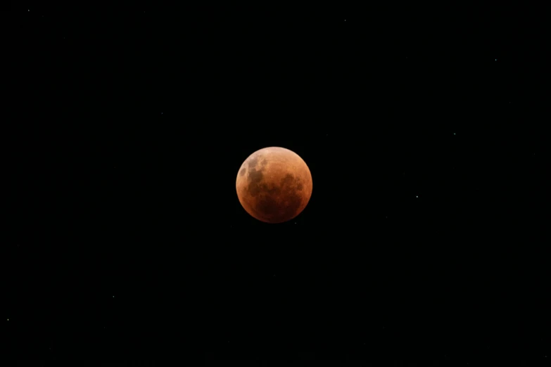 red moon in a black sky as the moon is very bright